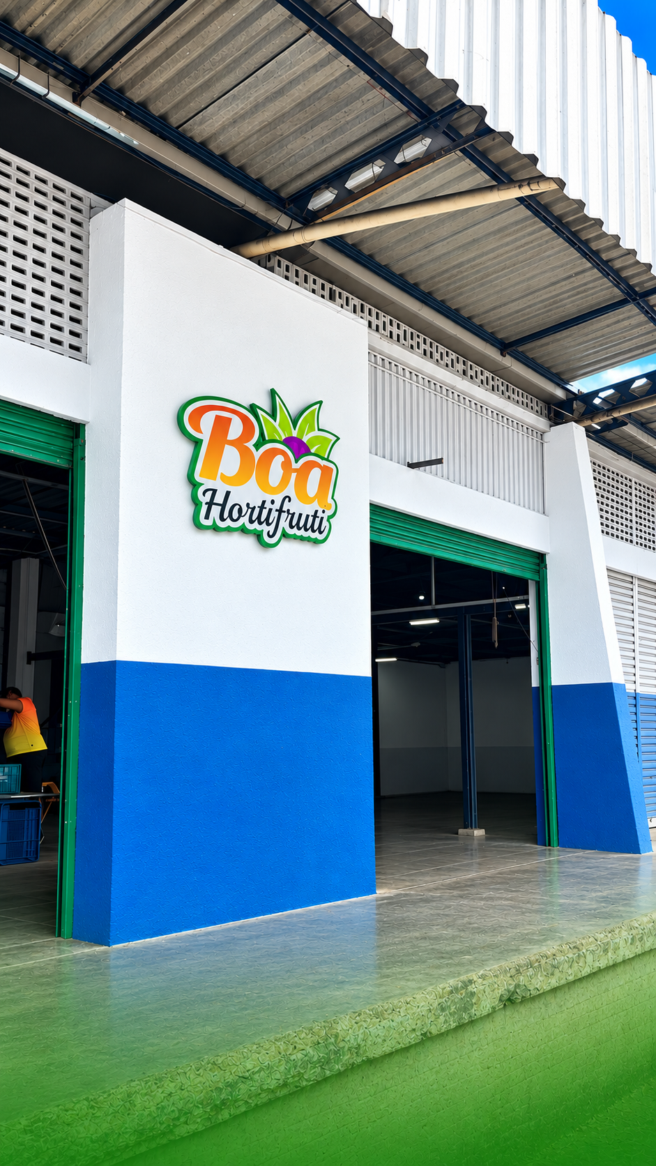 Fachada da Boa Hortifruti com a logomarca na parede branca e azul